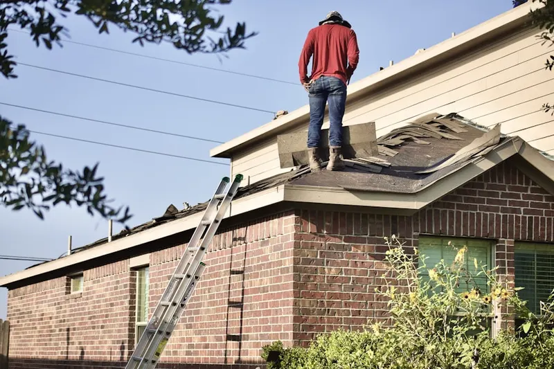 Professional roofer working on a residential roof in Houck Meadows